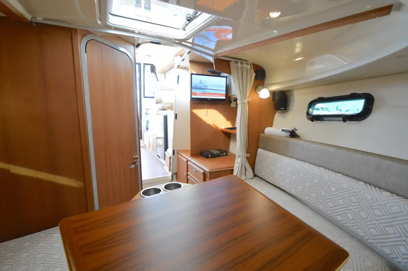 Slide: The Image of Interior of 2020 Ranger Tugs R-27 boat with wood finishes and seating area. - 27