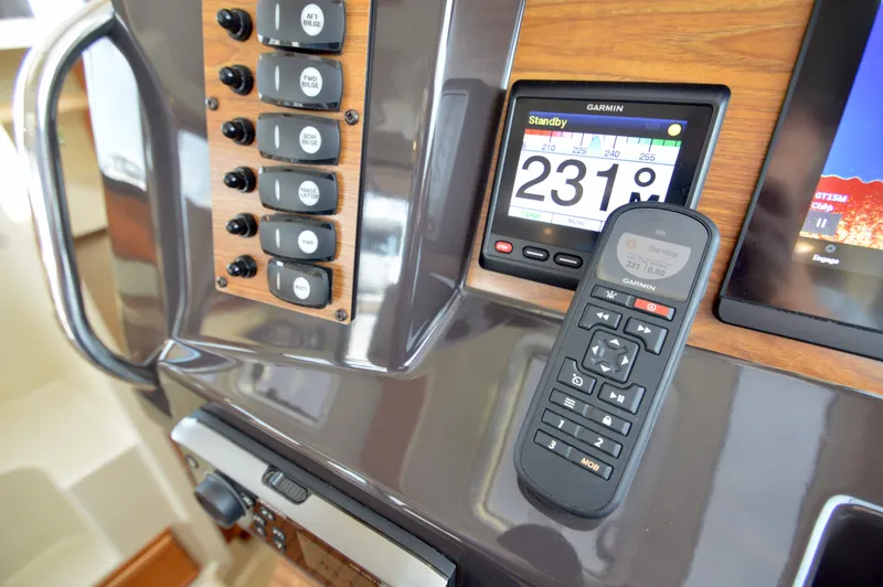 Slide: The Image of Control panel of 2020 Ranger Tugs R-27 with Garmin navigation system and remote. - 38