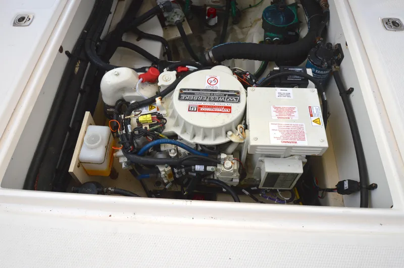 Slide: The Image of Engine compartment of a 2020 Ranger Tugs R-27 boat, featuring a Westerbeke generator. - 40