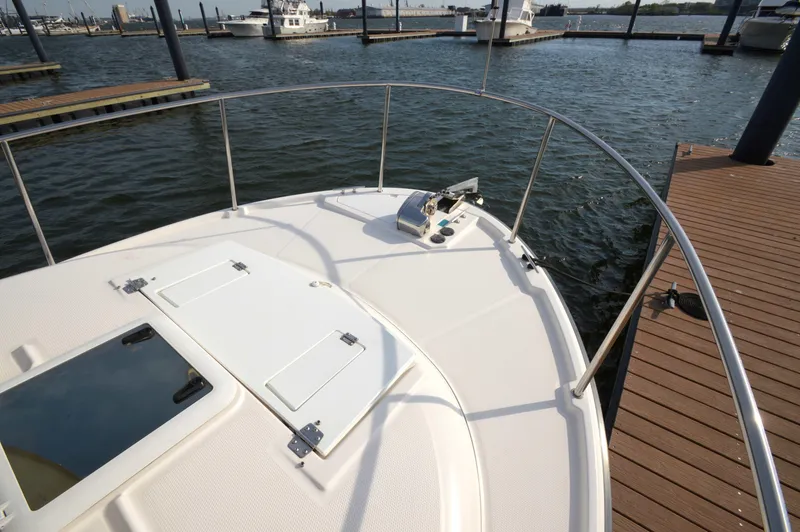 Slide: The Image of 2020 Ranger Tugs R-27 boat docked at marina, showing bow and deck details. - 6