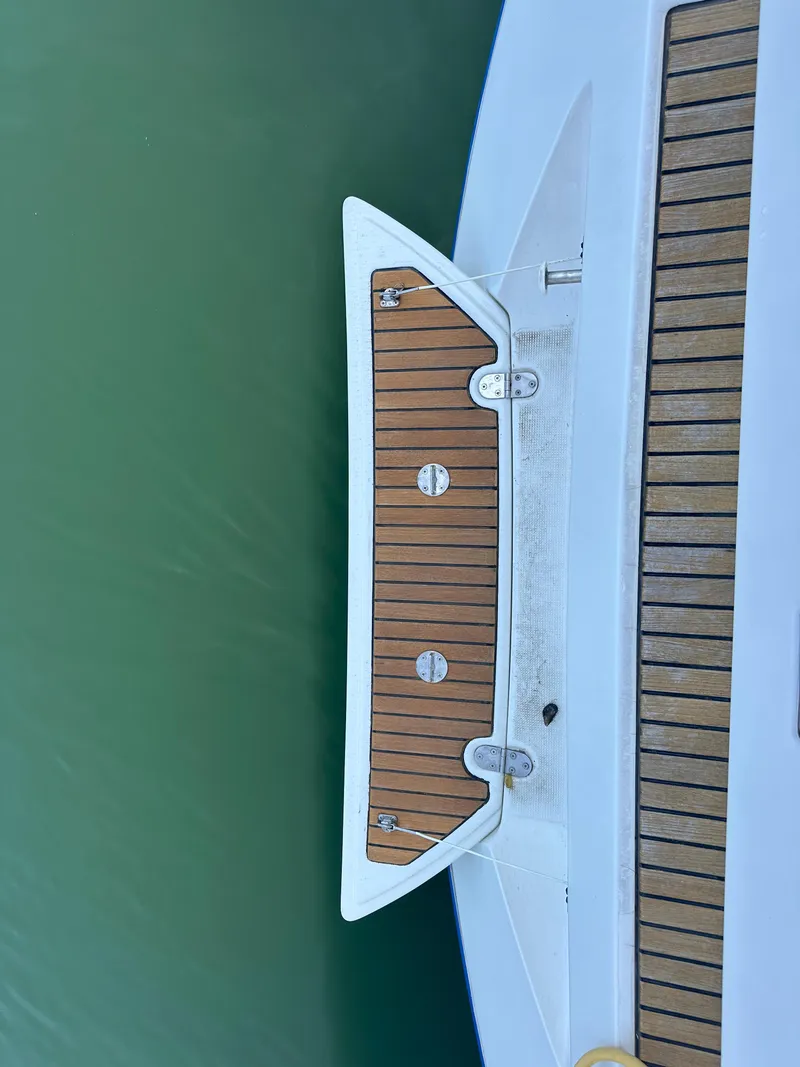 Slide: The Image of Beneteau First 47.7 yacht deck, 2002 model, featuring teak wood finish. - 16
