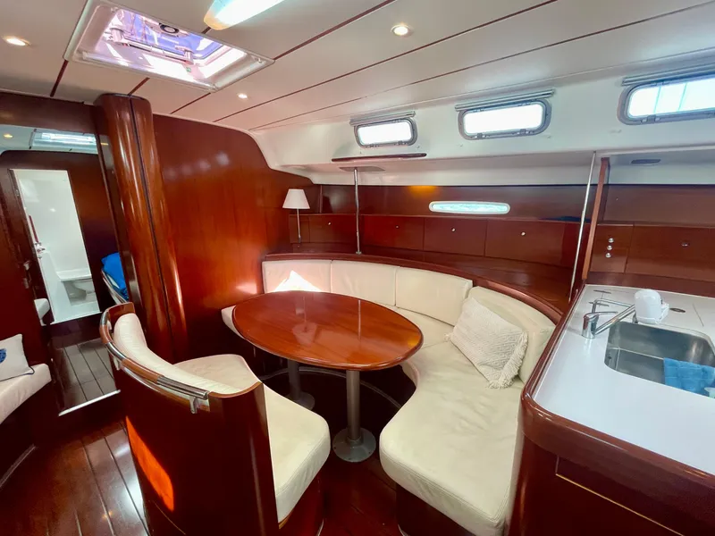 Slide: The Image of Luxurious interior of 2002 Beneteau First 47.7 yacht with elegant wood finish and cozy seating. - 23