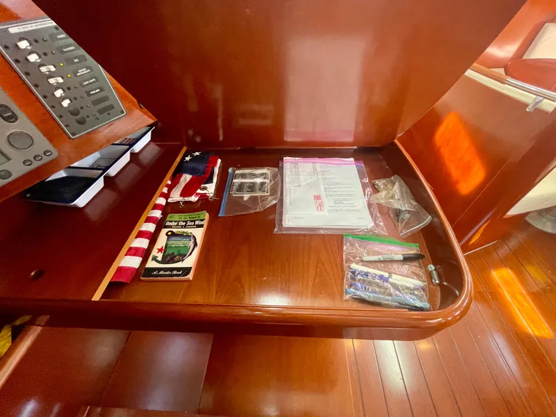 Slide: The Image of Navigation station on 2002 Beneteau First 47.7 yacht with equipment and documents. - 34