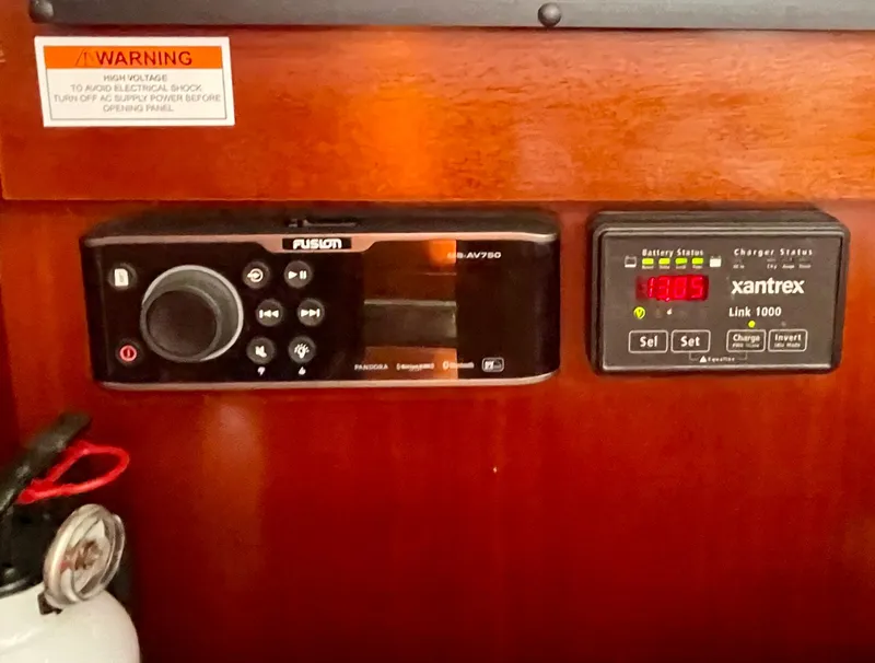Slide: The Image of Control panel on a 2002 Beneteau First 47.7 yacht, featuring Fusion and Xantrex systems. - 37