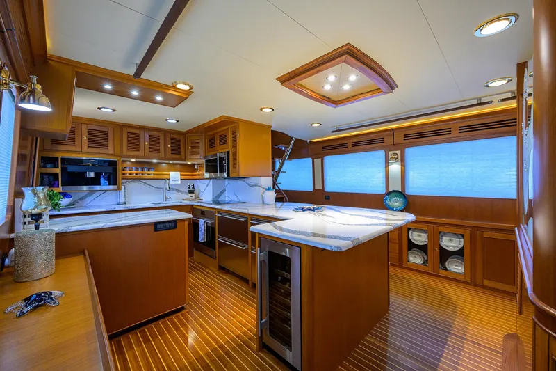 Slide: The Image of Luxurious kitchen interior on a 2011 Marlow 97 Explorer yacht, featuring wood finishes and modern appliances. - 17