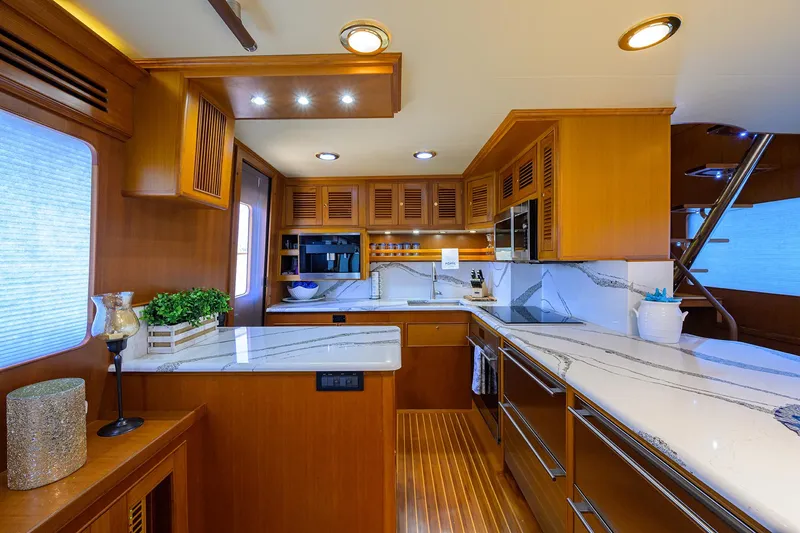 Slide: The Image of Luxurious kitchen interior of 2011 Marlow 97 Explorer yacht with modern amenities and wooden cabinetry. - 18