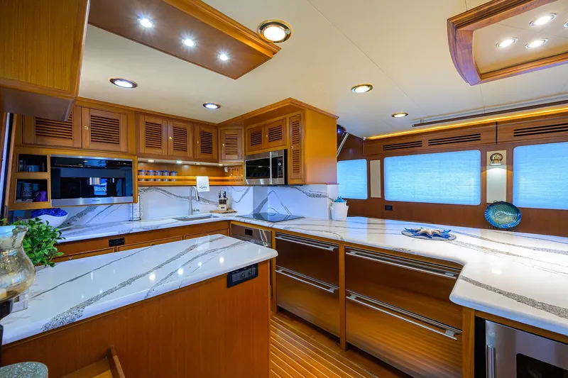 Slide: The Image of Luxurious kitchen interior of 2011 Marlow 97 Explorer yacht with modern amenities and wood finishes. - 19
