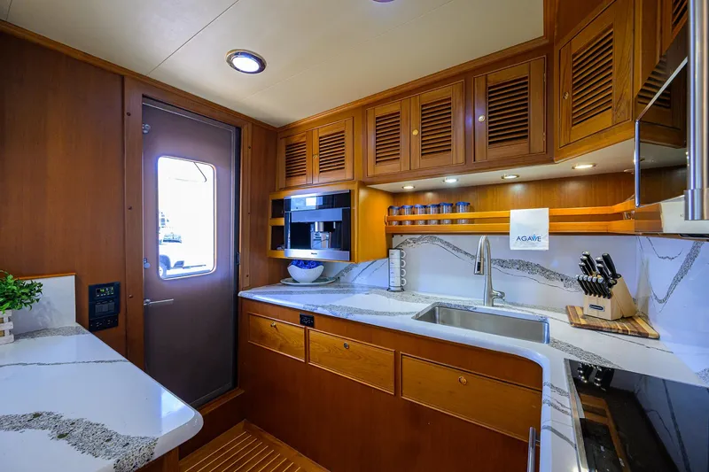 Slide: The Image of Luxurious kitchen interior of 2011 Marlow 97 Explorer yacht with modern amenities and wooden cabinetry. - 20