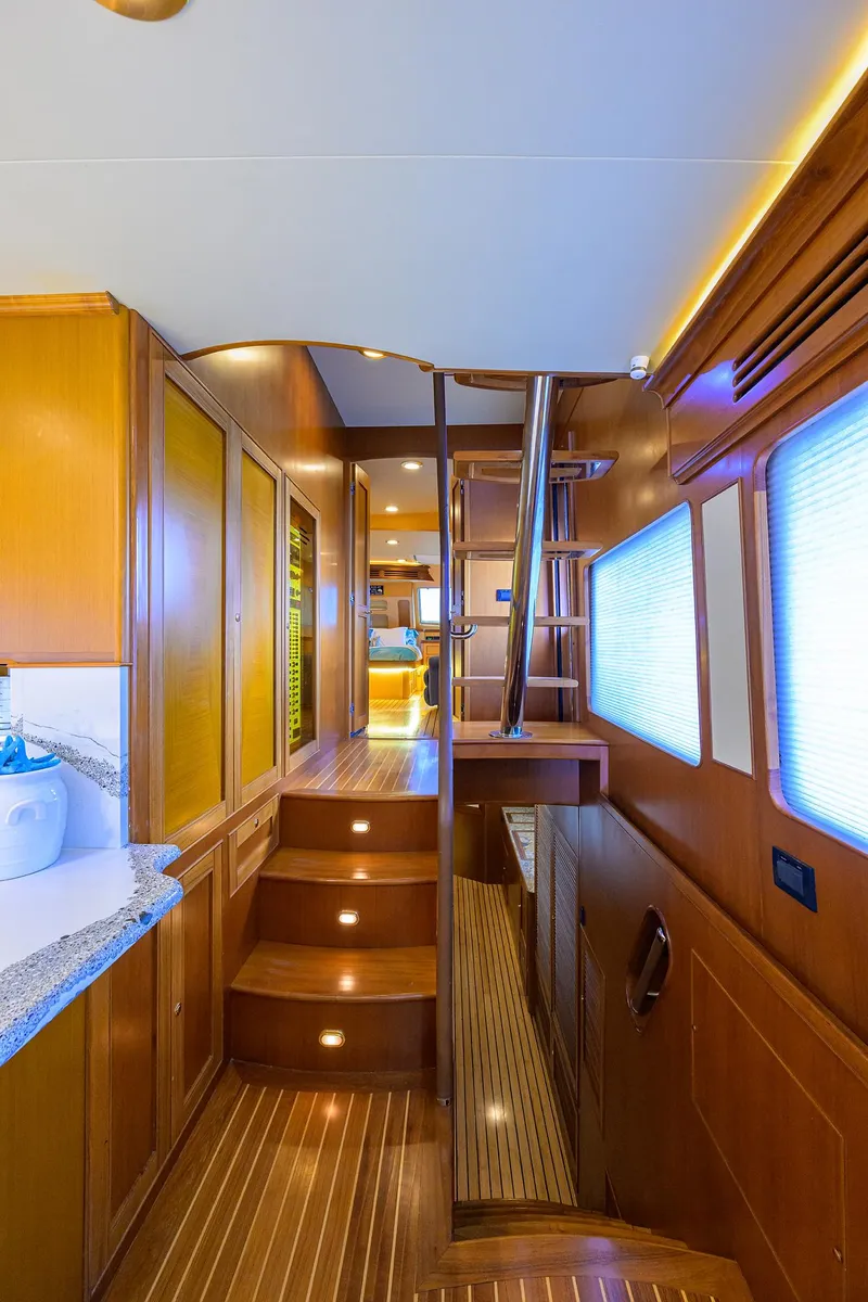 Slide: The Image of Interior of 2011 Marlow 97 Explorer yacht with wooden stairs and modern design. - 22