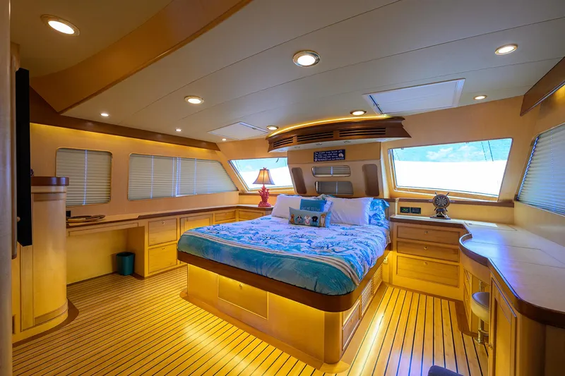 Slide: The Image of Luxurious bedroom interior of 2011 Marlow 97 Explorer yacht with wood accents and large windows. - 23