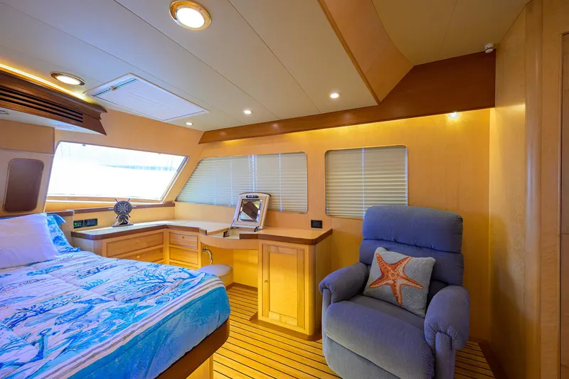 Slide: The Image of Luxurious cabin interior of 2011 Marlow 97 Explorer yacht with cozy bed and armchair. - 26