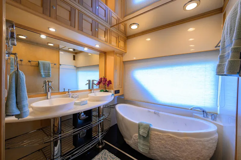 Slide: The Image of Luxurious bathroom in 2011 Marlow 97 Explorer yacht with dual sinks and freestanding tub. - 28