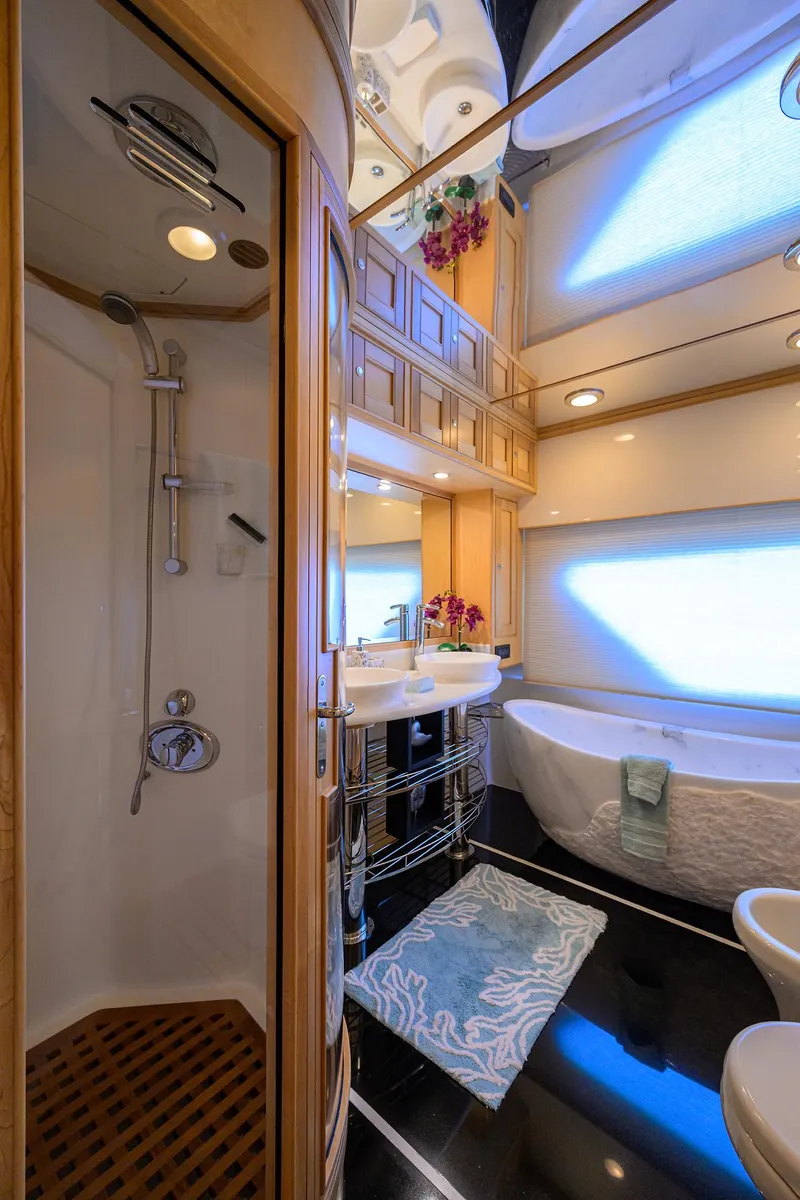 Slide: The Image of Luxurious bathroom in 2011 Marlow 97 Explorer yacht with shower, bathtub, and elegant decor. - 29