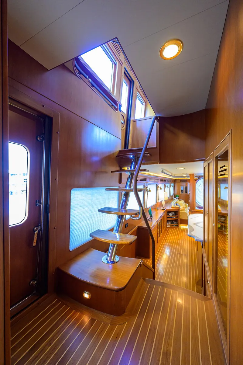 Slide: The Image of Interior of 2011 Marlow 97 Explorer yacht with wooden stairs and elegant design. - 3
