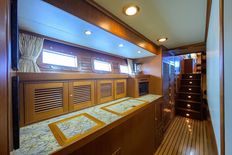 Slide: The Image of Luxurious wooden interior of 2011 Marlow 97 Explorer yacht with elegant lighting and cabinetry. - 30