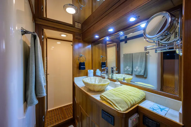 Slide: The Image of Luxurious Marlow 97 Explorer 2011 yacht bathroom with wooden accents and modern fixtures. - 33