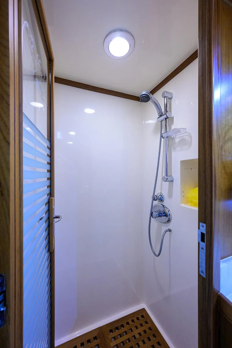 Slide: The Image of Shower area in 2011 Marlow 97 Explorer yacht with modern fixtures and wooden accents. - 34