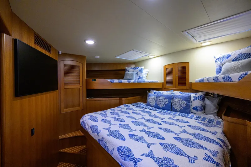 Slide: The Image of Luxurious cabin interior of 2011 Marlow 97 Explorer yacht with cozy bedding and wooden finishes. - 37