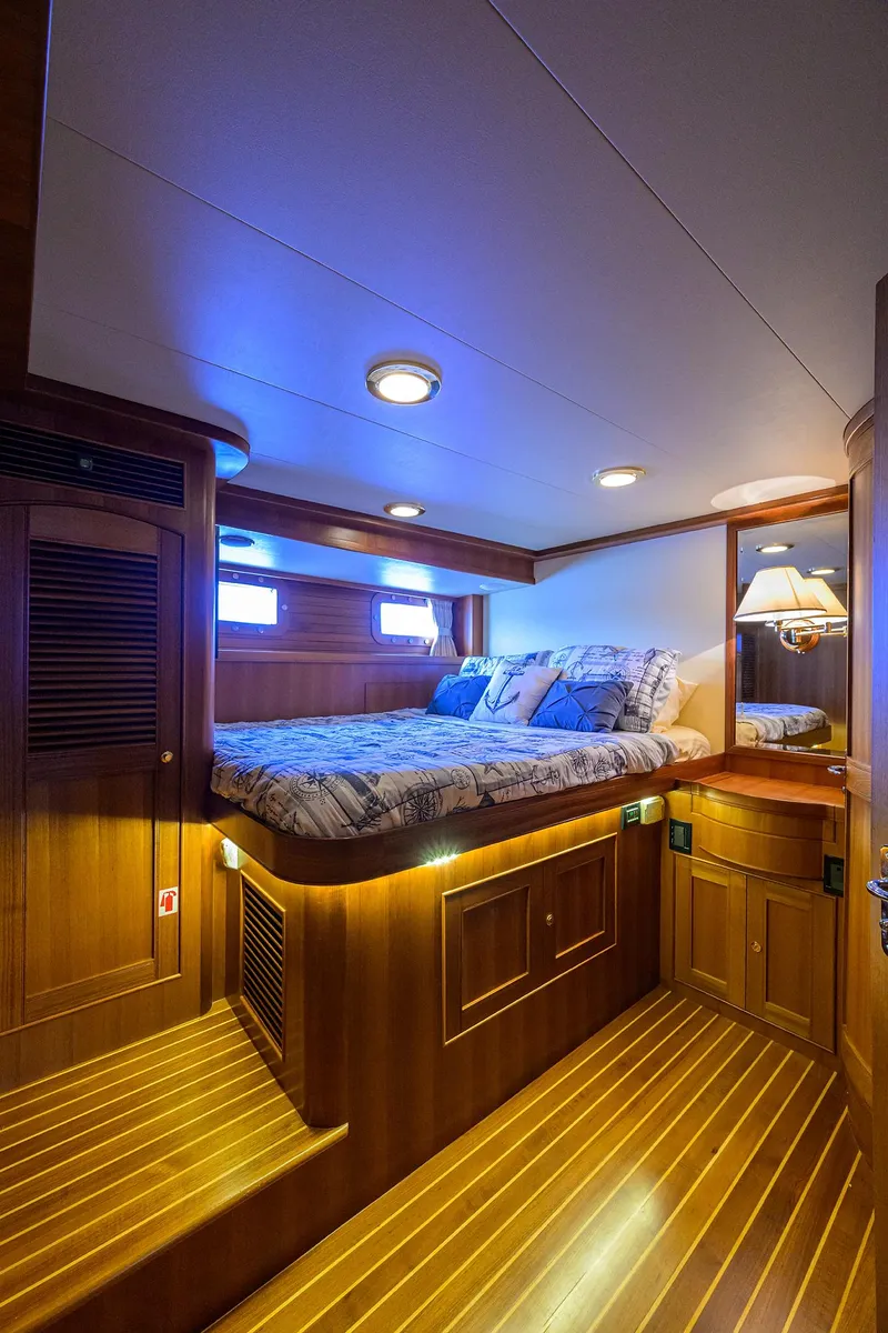 Slide: The Image of Luxurious cabin interior of 2011 Marlow 97 Explorer yacht with cozy bed and wooden finishes. - 43