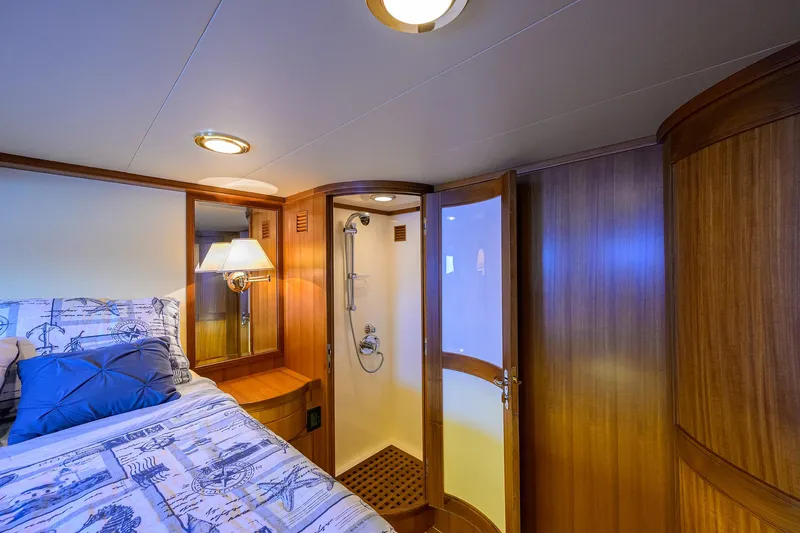 Slide: The Image of Luxurious cabin interior of 2011 Marlow 97 Explorer yacht with bed and ensuite shower. - 44