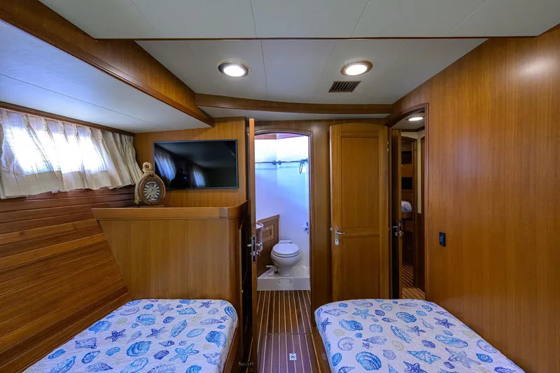 Slide: The Image of Cabin interior of 2011 Marlow 97 Explorer yacht with twin beds and ensuite bathroom. - 47
