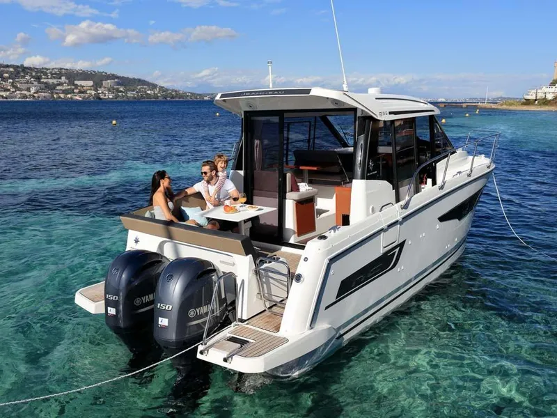 Slide: The Image of 2024 Jeanneau NC 895 boat on clear water, people enjoying leisure time. - 1