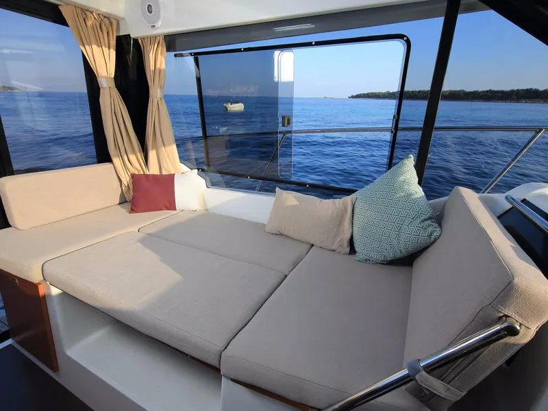 Slide: The Image of Interior of 2024 Jeanneau NC 895 boat with comfortable seating and ocean view. - 10