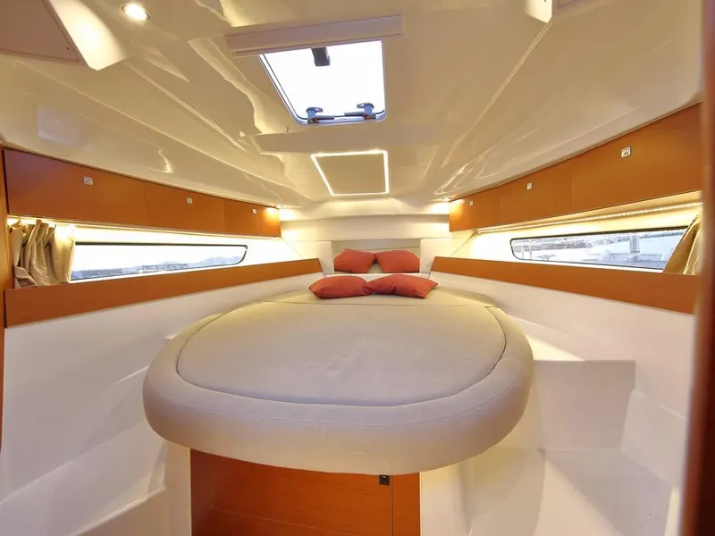 Slide: The Image of 2024 Jeanneau NC 895 cabin interior with cozy bed and modern lighting. - 17