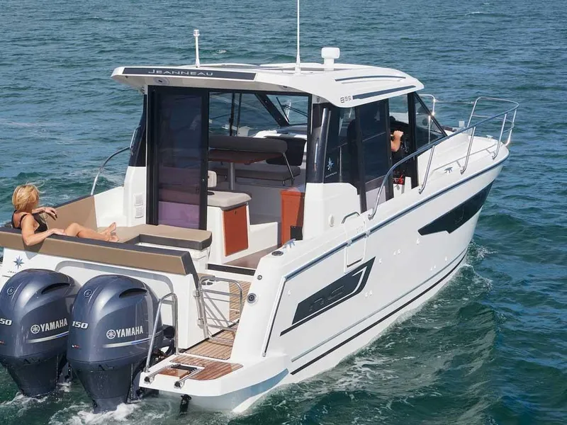 Slide: The Image of 2024 Jeanneau NC 895 boat with Yamaha engines cruising on the water. - 2