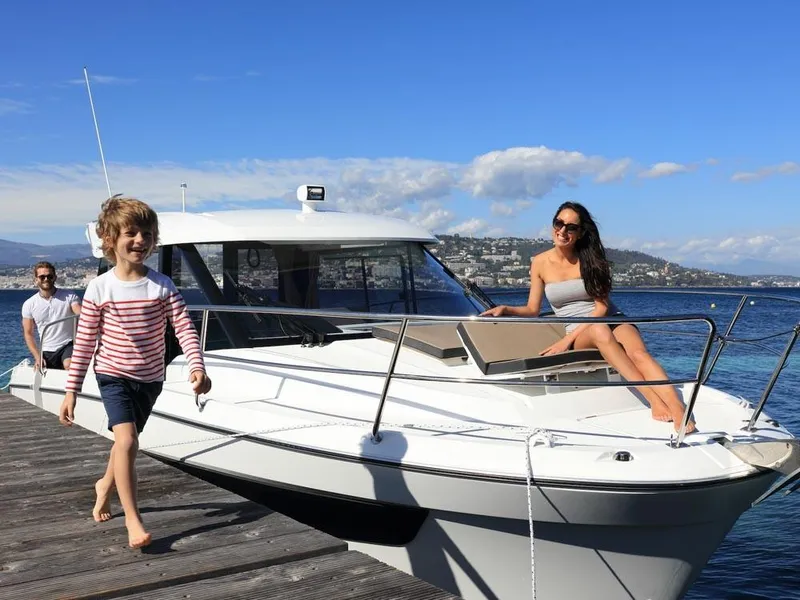 Slide: The Image of 2024 Jeanneau NC 895 boat docked with people enjoying a sunny day. - 4