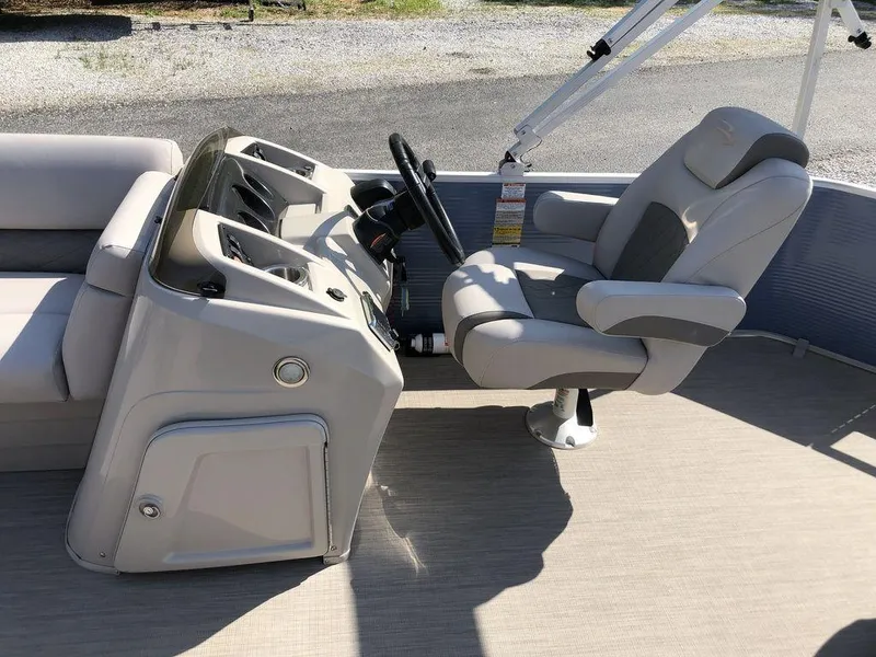 Slide: The Image of 2018 Bennington 22SLX boat interior with steering console and captain's chair. - 4
