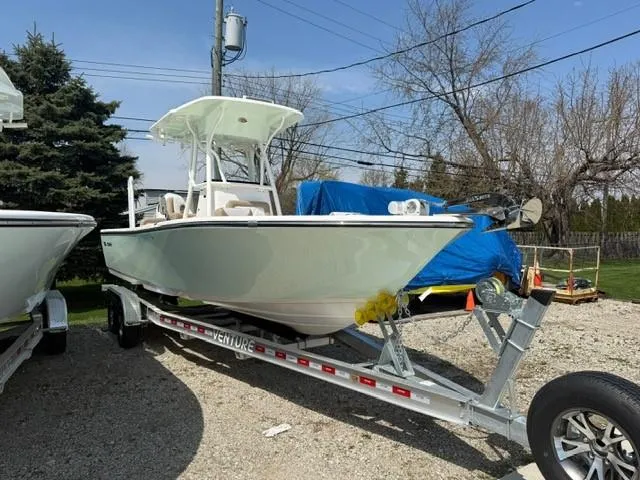 The Image of 2025 Sea Born LX24 Center Console boat on trailer, parked outdoors. - 0