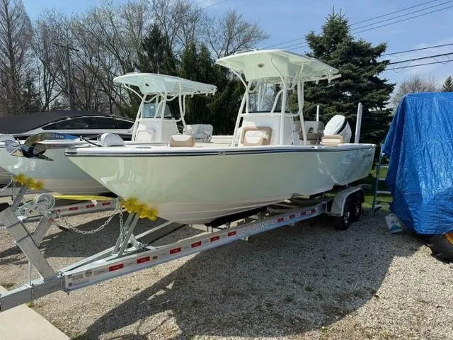 Slide: The Image of 2025 Sea Born LX24 Center Console boat on trailer, parked outdoors. - 18