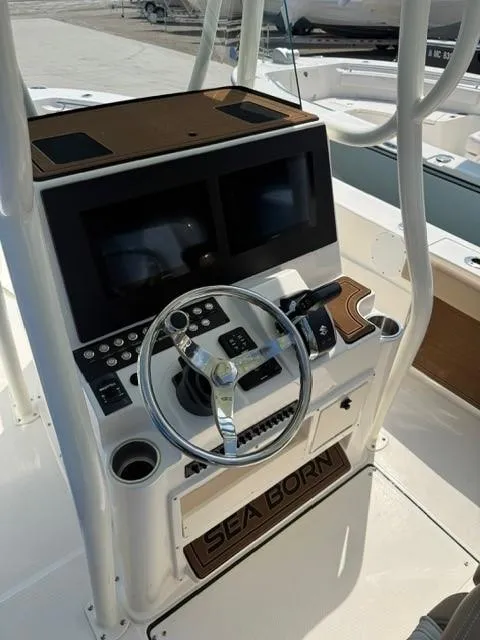 Slide: The Image of 2025 Sea Born LX24 Center Console boat dashboard with steering wheel and controls. - 20
