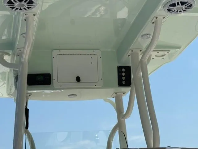 Slide: The Image of 2025 Sea Born LX24 Center Console boat's overhead console with speakers and controls. - 25