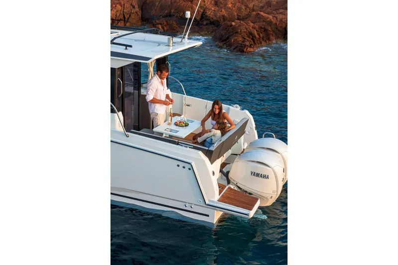 Slide: The Image of Couple enjoying leisure time on Jeanneau NC 895 Series 2 boat, 2025 model, near rocky shore. - 35
