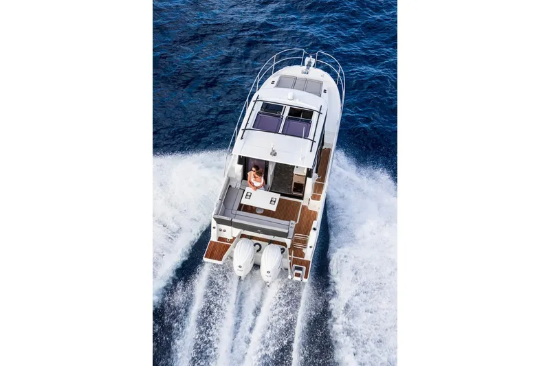 Slide: The Image of 2025 Jeanneau NC 895 Series 2 cruising on open water, aerial view. - 43