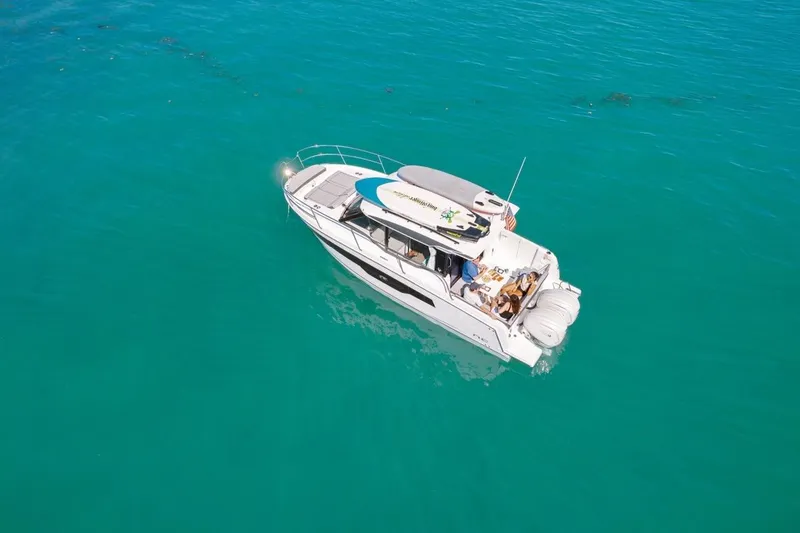 Slide: The Image of 2025 Jeanneau NC 895 Series 2 boat cruising on clear turquoise waters. - 79
