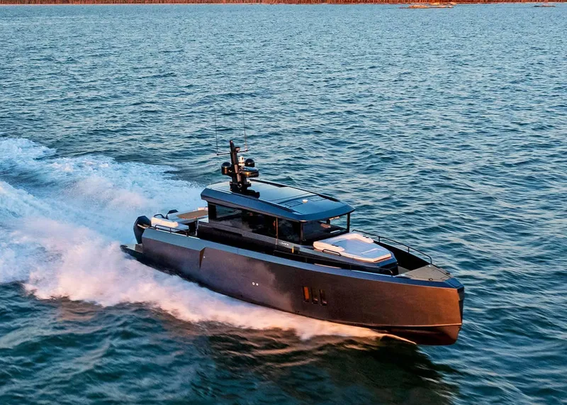 Slide: The Image of 2025 XO Boats EXPLR 44 cruising on open water at high speed. - 10