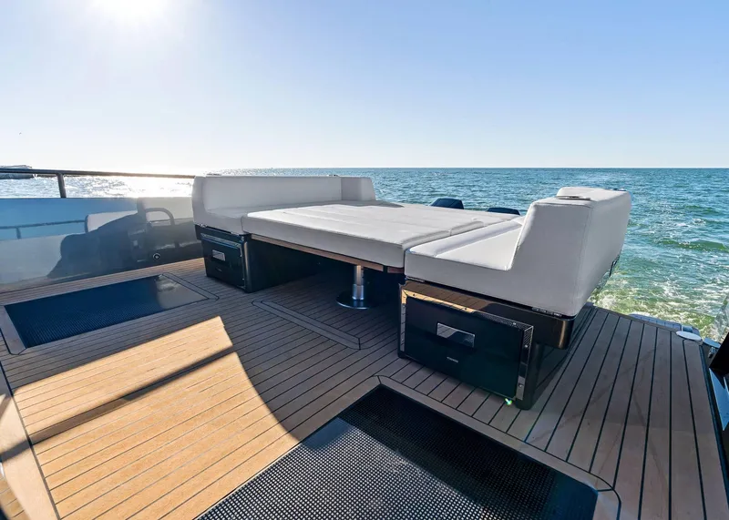 Slide: The Image of 2025 XO Boats EXPLR 44 deck with luxurious seating, overlooking the ocean. - 12