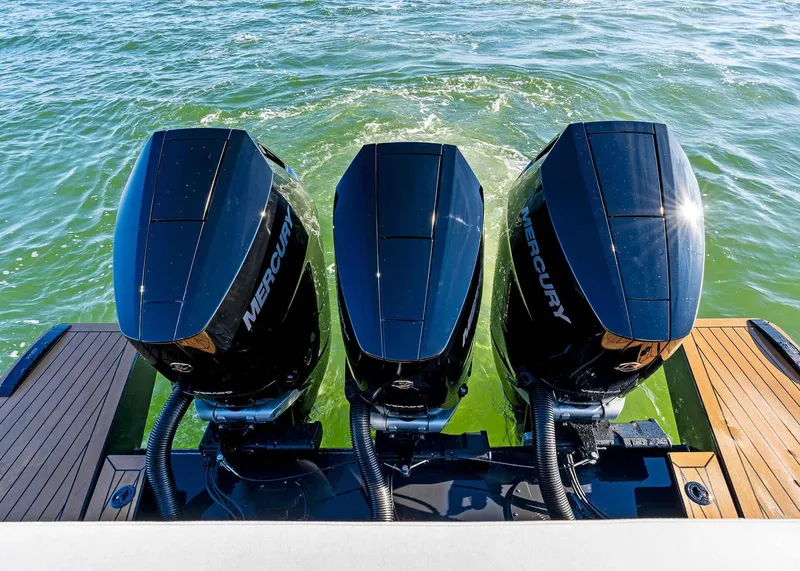 Slide: The Image of Triple Mercury outboard engines on 2025 XO Boats EXPLR 44, cruising on water. - 13