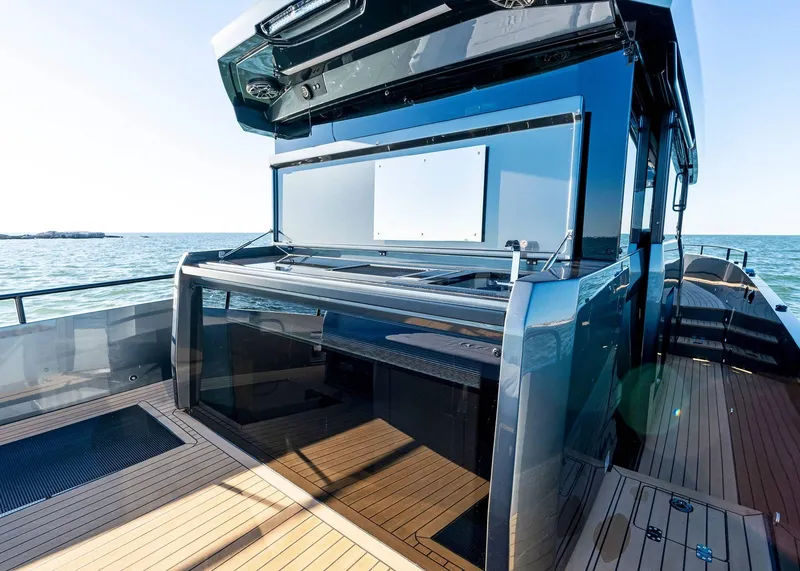 Slide: The Image of 2025 XO Boats EXPLR 44 yacht with sleek design and spacious deck on open water. - 17