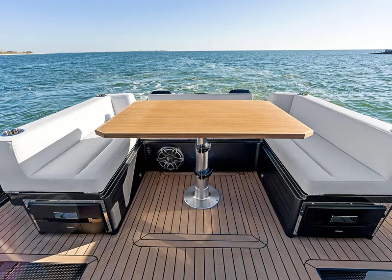 Slide: The Image of Luxury seating area on 2025 XO Boats EXPLR 44, overlooking serene ocean waters. - 20