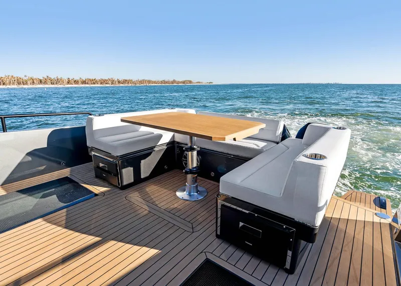 Slide: The Image of Luxury deck seating on 2025 XO Boats EXPLR 44, overlooking serene ocean waters. - 21
