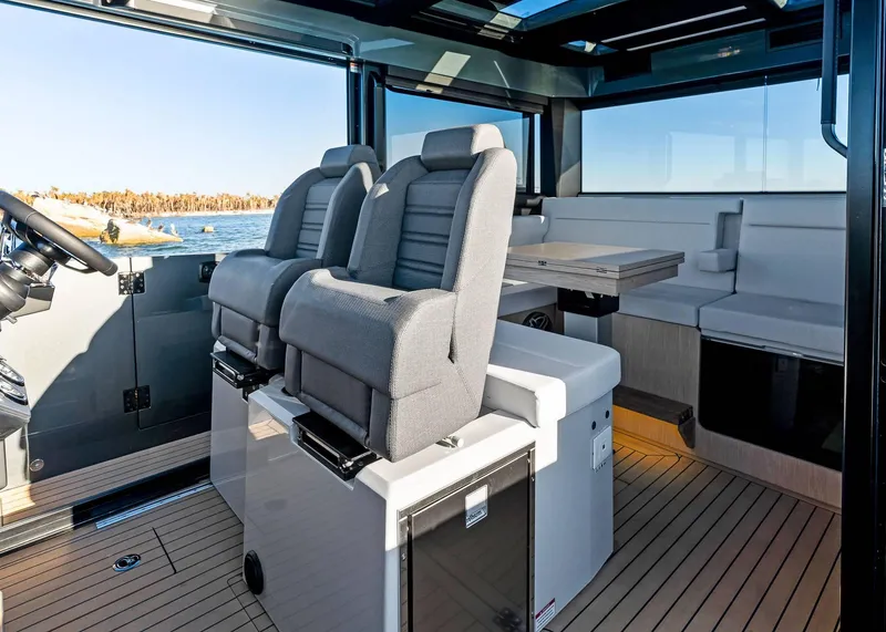 Slide: The Image of 2025 XO Boats EXPLR 44 interior with modern seating and panoramic windows. - 26