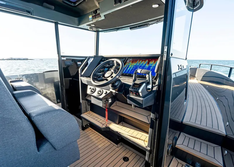Slide: The Image of 2025 XO Boats EXPLR 44 cockpit with modern navigation system and sleek design. - 29