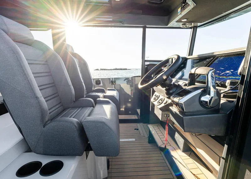 Slide: The Image of Interior of 2025 XO Boats EXPLR 44, featuring modern helm and seating with ocean view. - 31