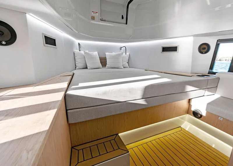 Slide: The Image of Luxurious interior cabin of 2025 XO Boats EXPLR 44 with modern bedding and ambient lighting. - 36