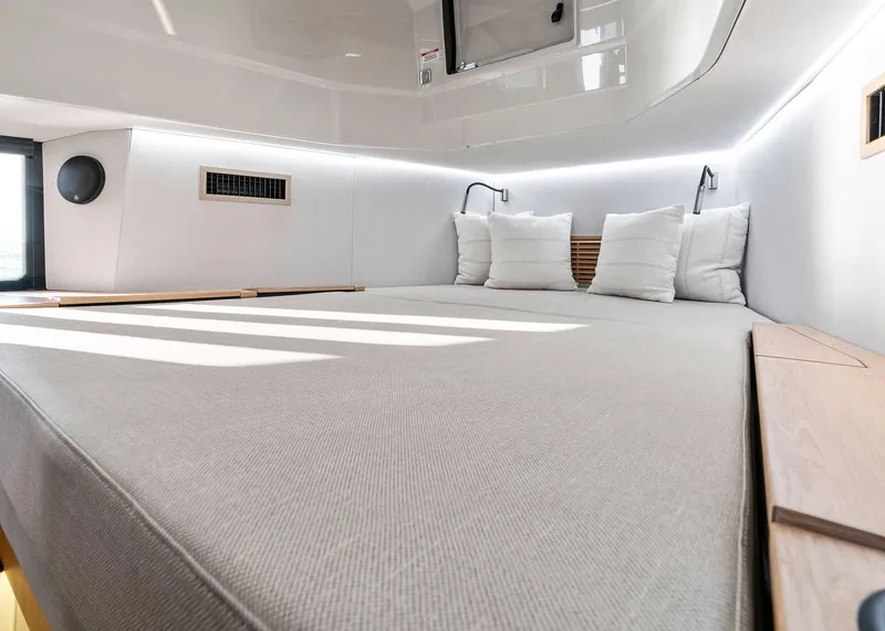 Slide: The Image of Luxurious interior cabin of 2025 XO Boats EXPLR 44 with modern bedding and lighting. - 38