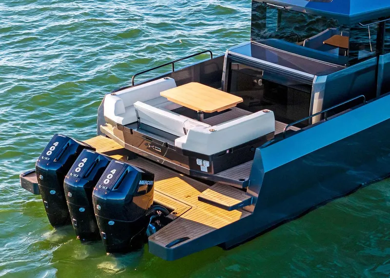 Slide: The Image of 2025 XO Boats EXPLR 44 with triple Mercury 400 engines on water. - 8